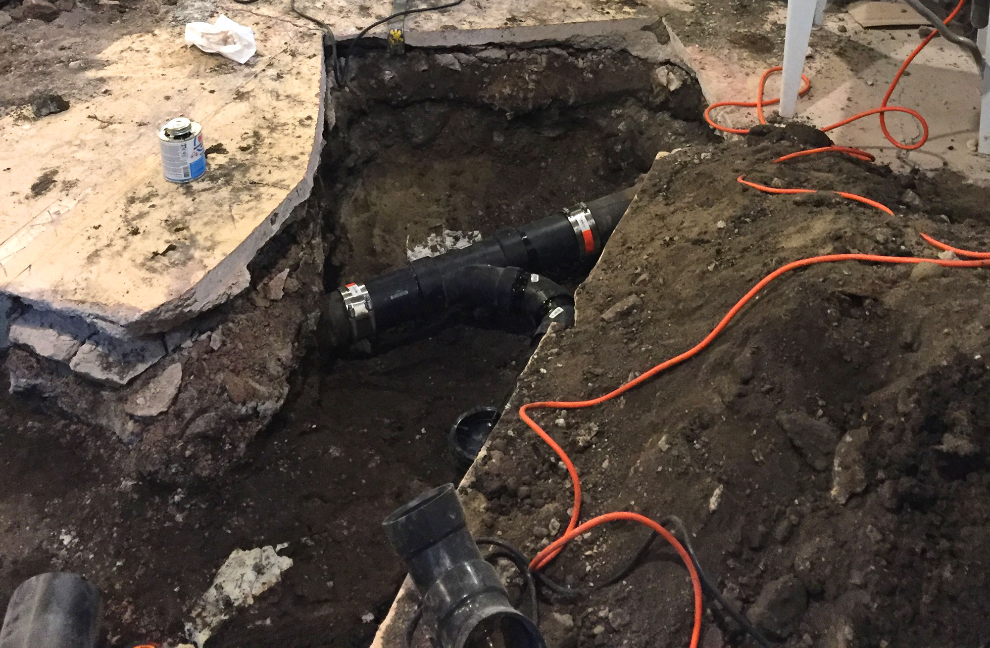 deep hole for pipe installation in basement for bathroom